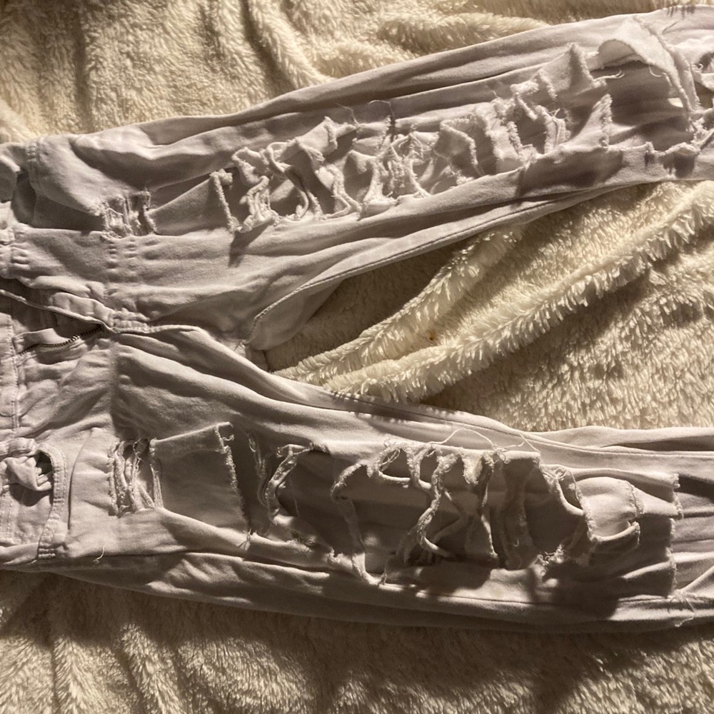 All white jeans with holes